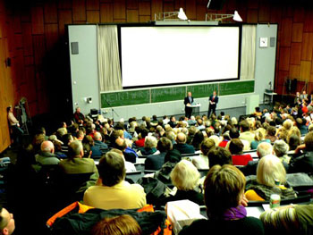 The lecture resumes. The blackboard behind Dr Gitt reads, ‘No! We’re going to heaven’