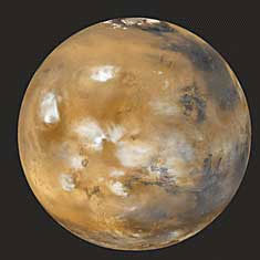 The planet Mars, like Earth, has clouds in its atmosphere and a deposit of ice at its north pole. But unlike Earth, Mars has no liquid water on its surface. The rustlike color of Mars comes from the large amount of iron in the planet’s soil.